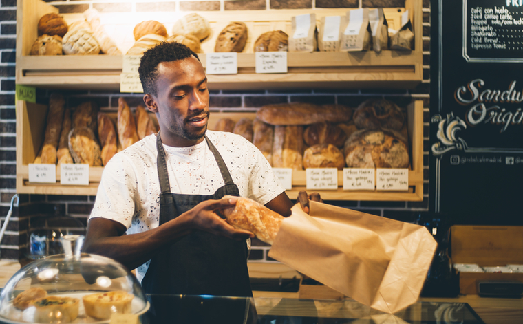A small business bakery owner fulfills orders from his customers, knowing he has the security offered by a Selective business insurance policy.
